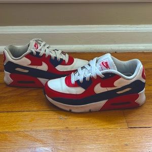 These are Nike Air Max shoes. Red,white, and blue.